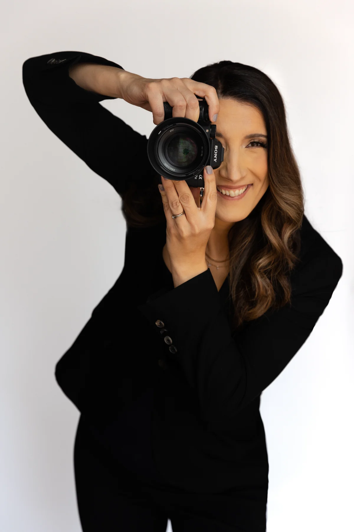 Silvia Alexiev, founder of Anotherframe Studio, holding her Sony camera