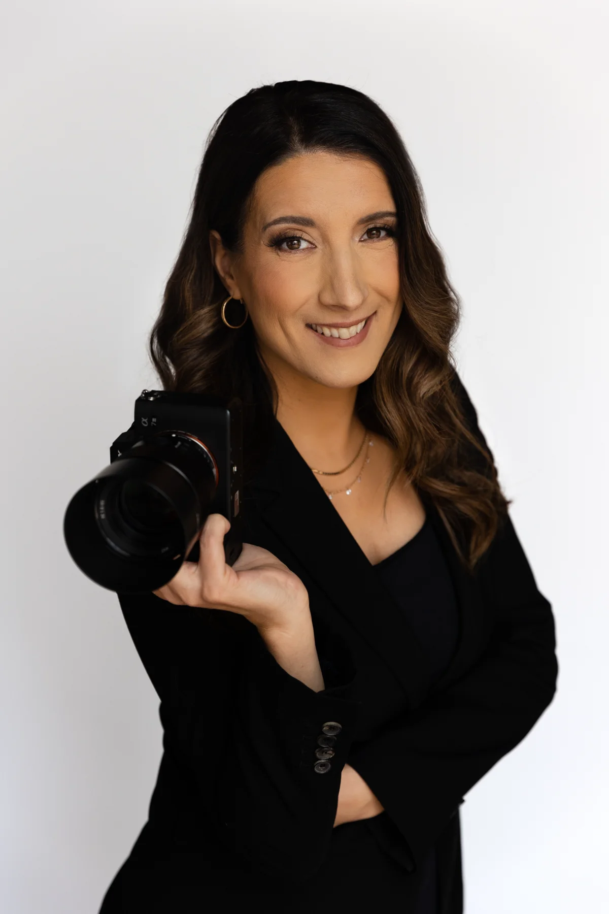 Silvia Alexiev photographing with a camera raised to her face, Anotherframe Studio, Washington DC